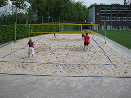 Personen spielen Beachvolleyball.